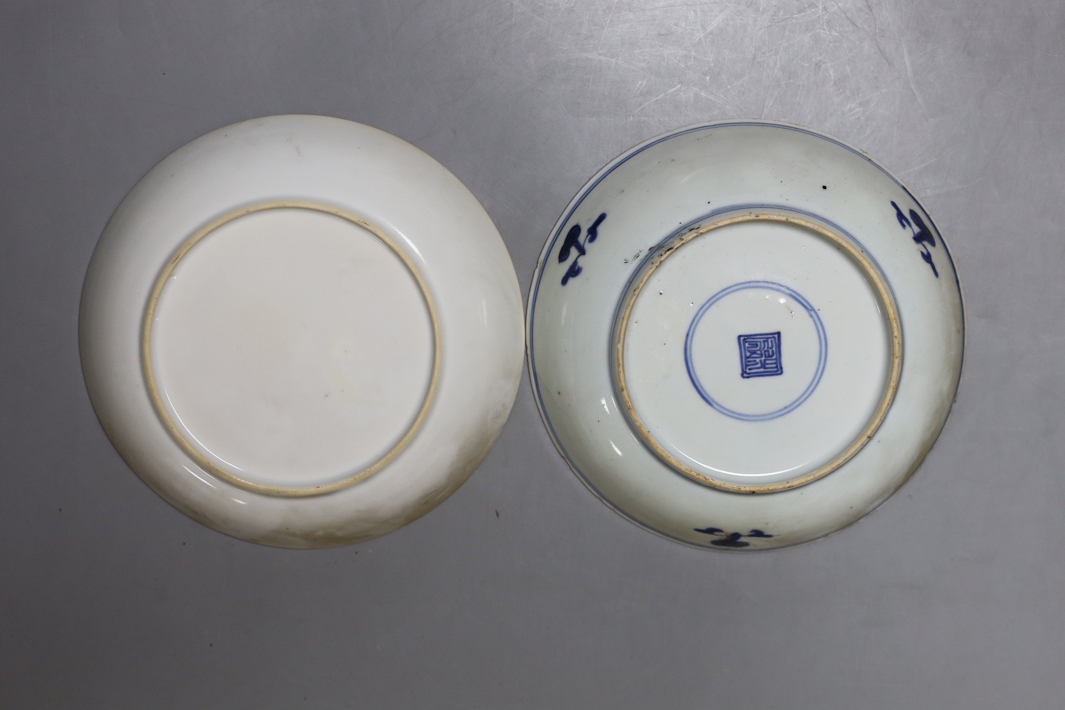 An 18th century Chinese export famille rose plate and two similar blue and white saucers, largest 23cm